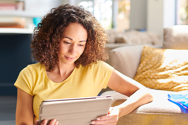 Woman using tablet in living room